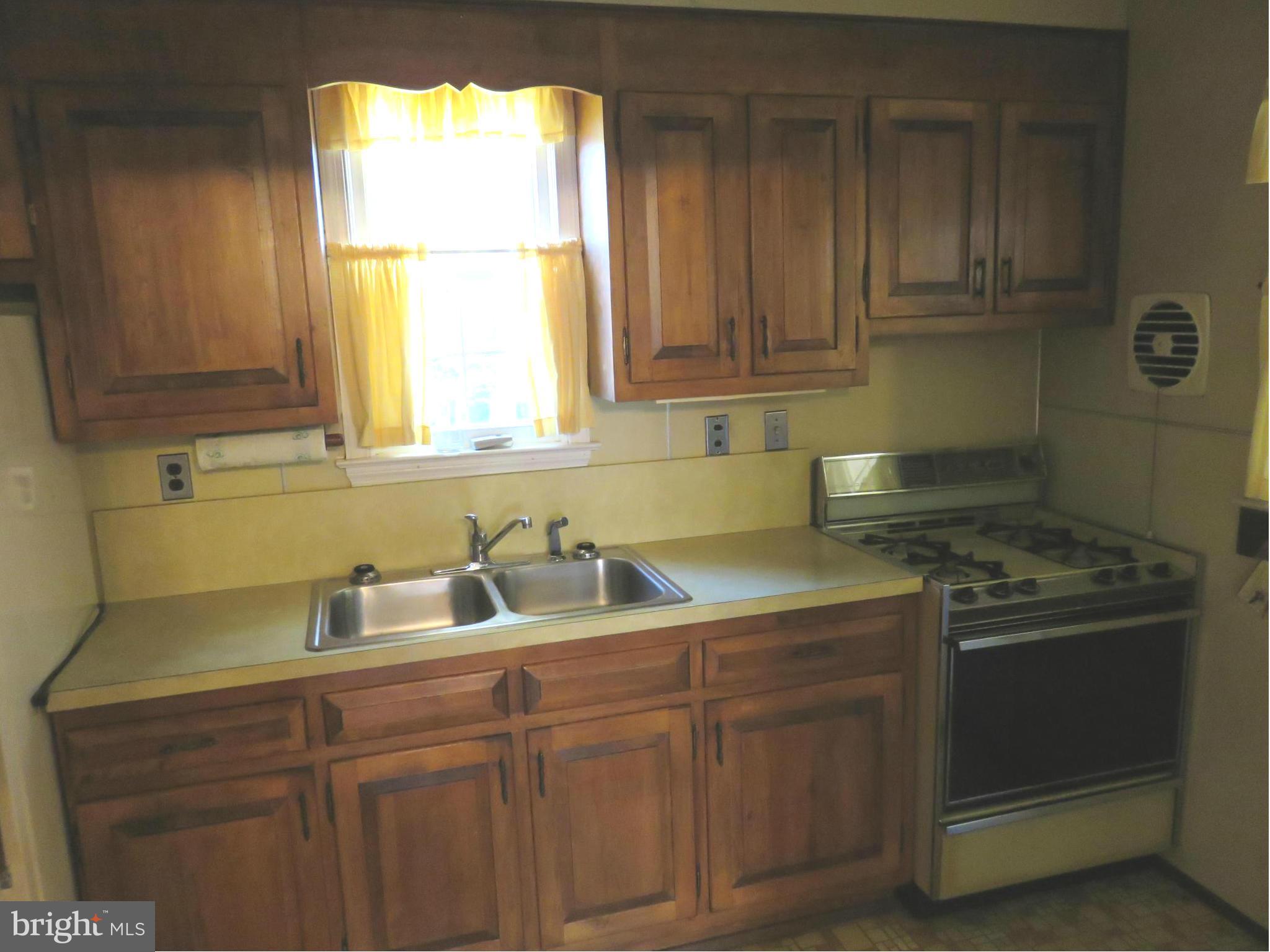 1747 Ellinwood Road Baltimore, MD 21237 - Photo 12 of 26 a kitchen with stainless steel appliances granite countertop a sink a stove and cabinets