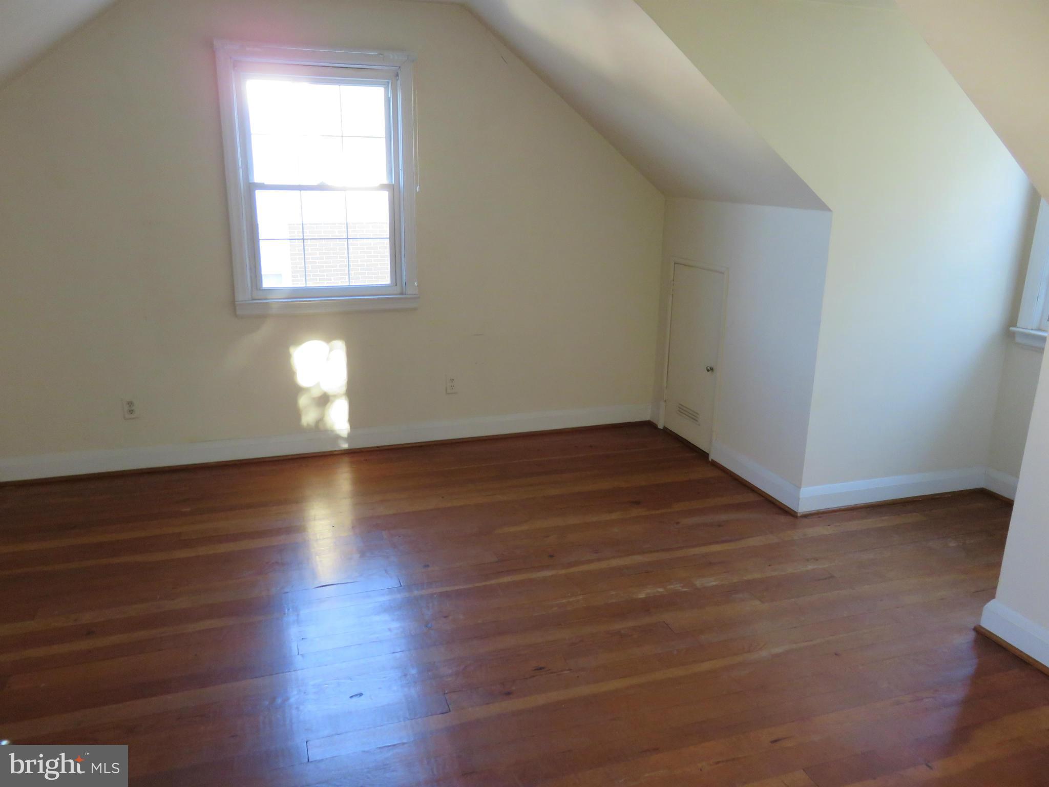 1747 Ellinwood Road Baltimore, MD 21237 - Photo 16 of 26 an empty room with wooden floor and windows