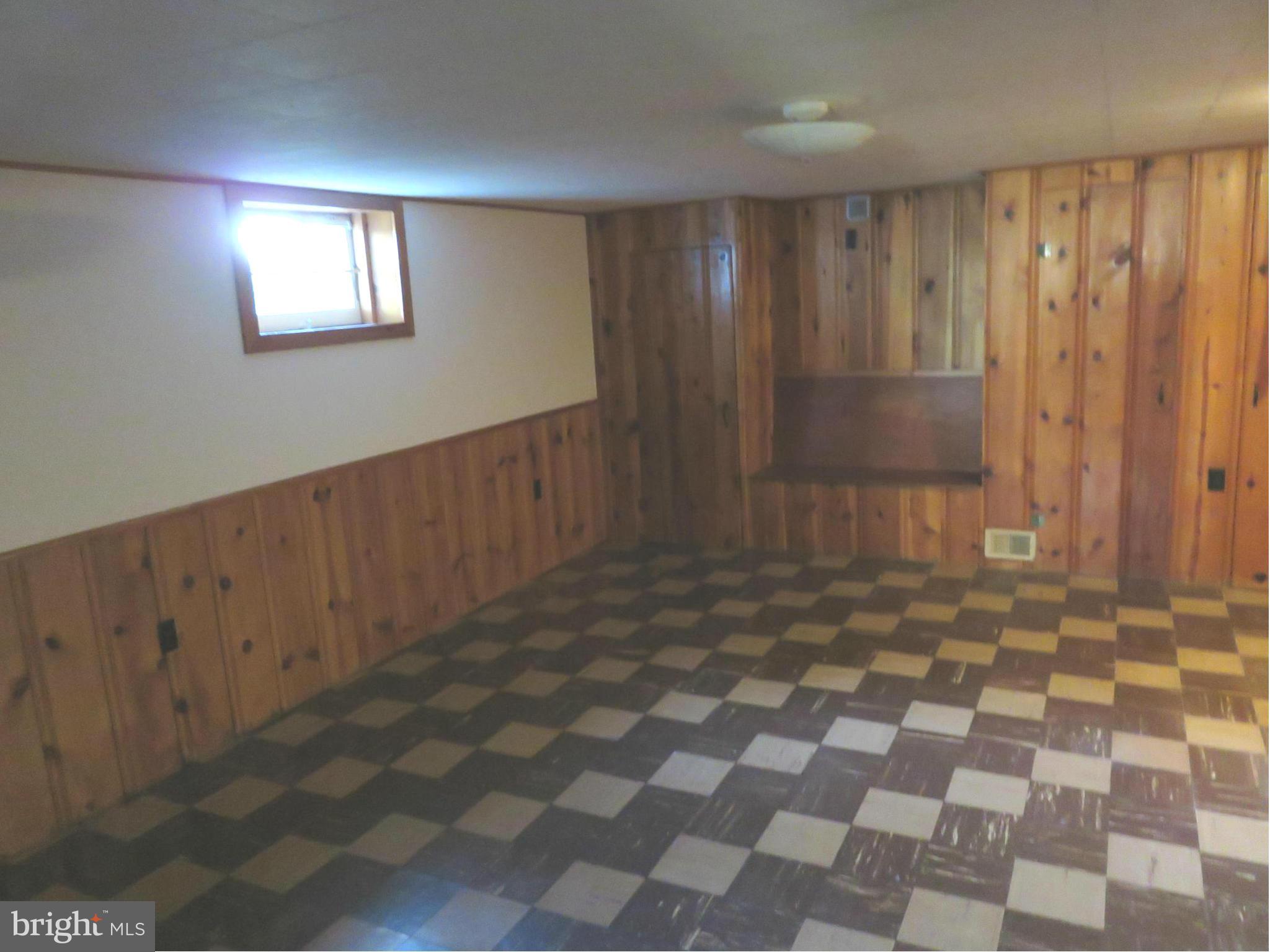 1747 Ellinwood Road Baltimore, MD 21237 - Photo 17 of 26 a view of a hallway with a black white checkered floor