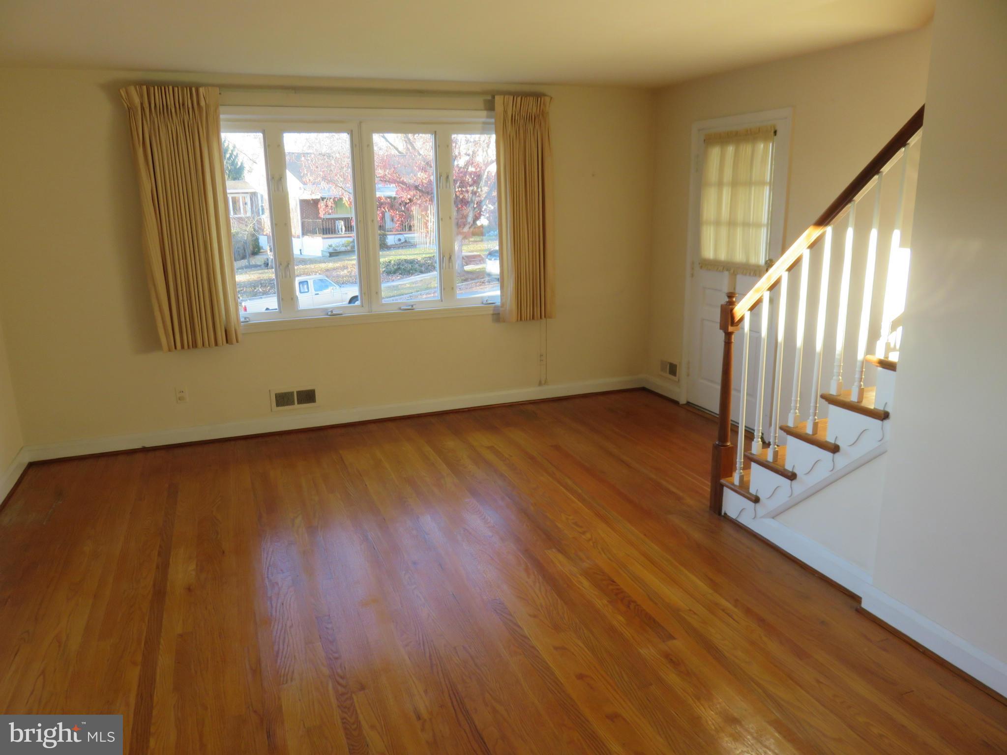 1747 Ellinwood Road Baltimore, MD 21237 - Photo 4 of 26 a view of an empty room with wooden floor and a window