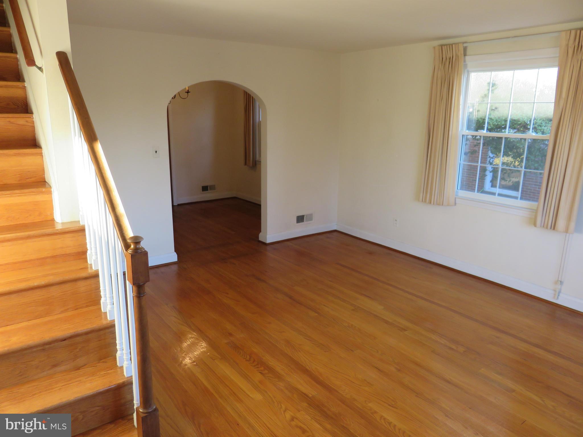 1747 Ellinwood Road Baltimore, MD 21237 - Photo 8 of 26 a view of a room with wooden floor and stairs