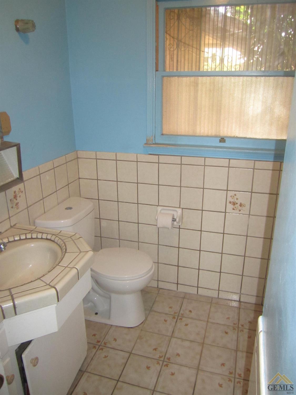 Undisclosed Address Bakersfield, CA 93305 - Photo 9 of 18 a white toilet sitting next to a window