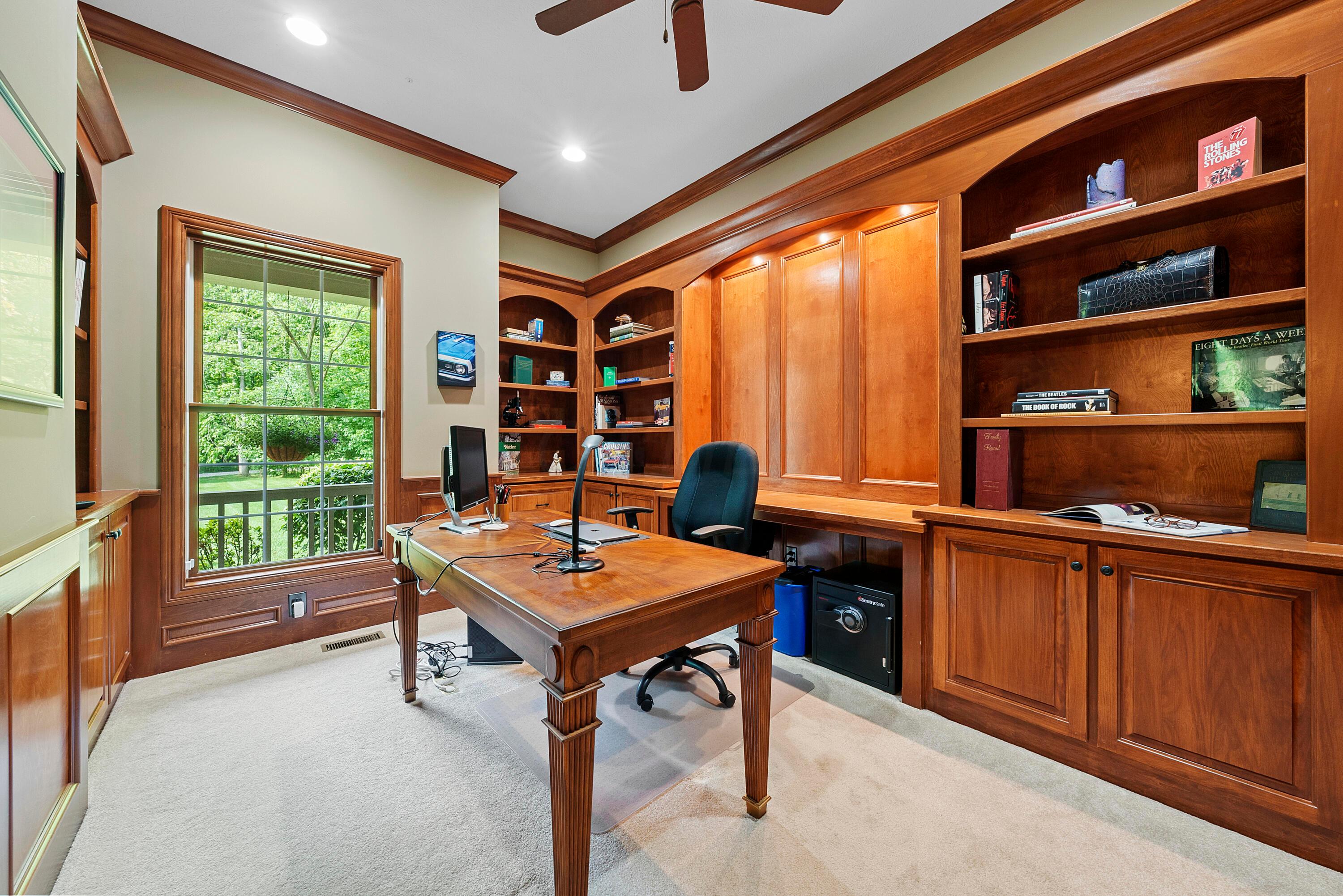 5761 Hughes Road Galena, OH 43021 - Photo 11 of 43 Private home office with French doors, wood library panel wainscoting & built-in workstation with bookcases & cabinets, 10’ ceiling, built-in sound system speakers.