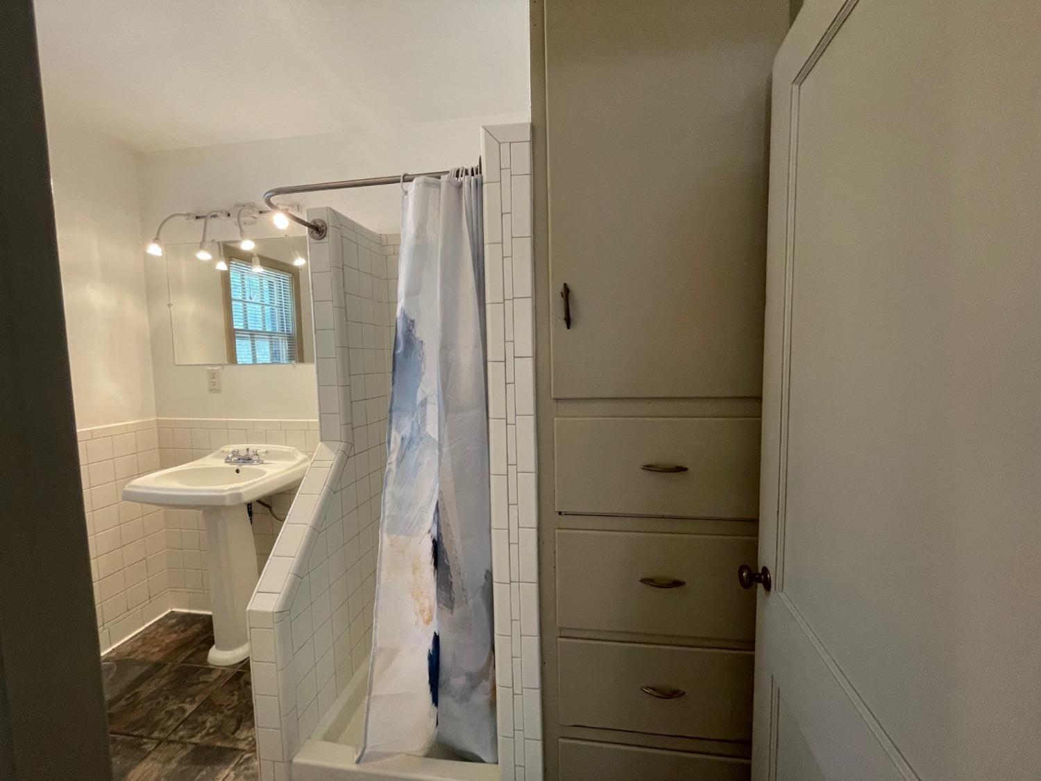3018 29th Street Lubbock, TX 79410 - Photo 7 of 14 a bathroom with a shower