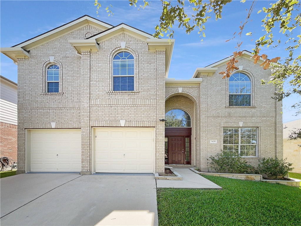 3428 Shiraz Loop Round Rock, TX 78665 - Photo 1 of 1 a front view of a house with garden