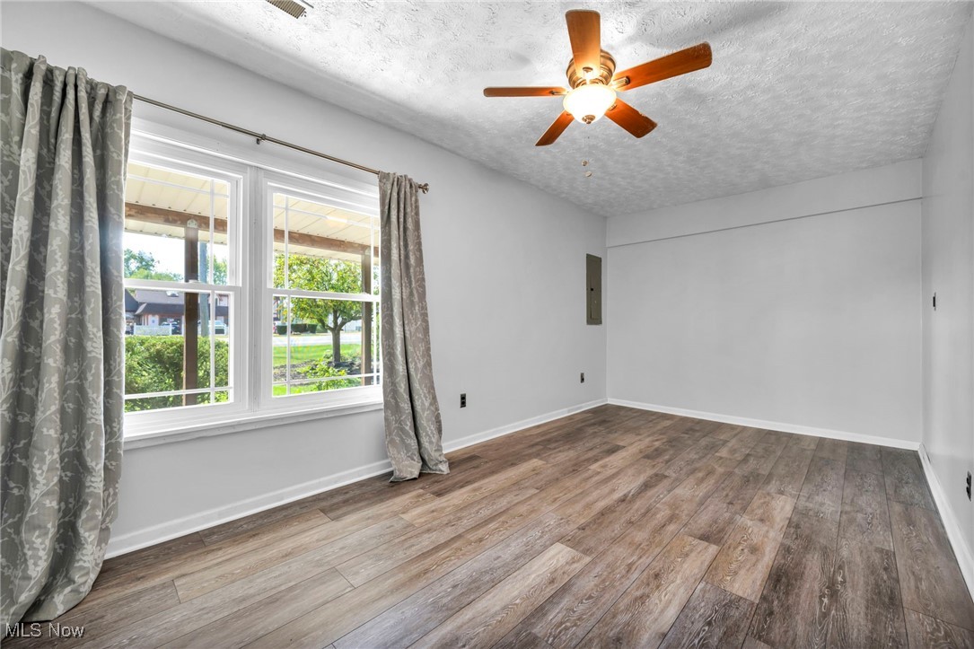 39020 Center Ridge Road North Ridgeville, OH 44039 - Photo 24 of 30 Spare room with ceiling fan, hardwood / wood-style flooring, electric panel, and a textured ceiling
