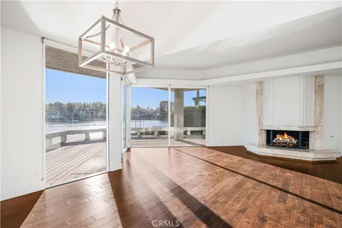 a view of a livingroom with a furniture wooden floor and a chandelier