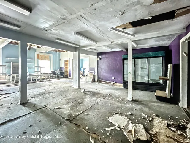 a view of a porch with a table and chairs