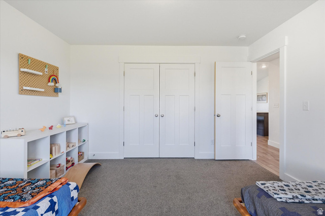 1422 West 3410th Street South Logan, UT 84321 - Photo 23 of 33 Light-filled room featuring neutral wall paint, gray carpet flooring, and white trim