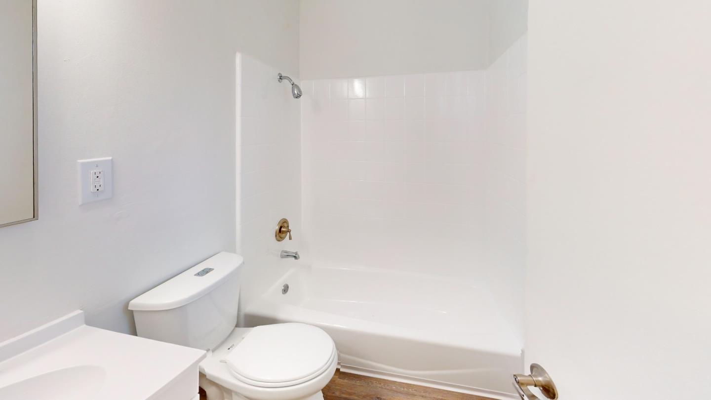 1222 Irwin Street San Rafael, CA 94901 - Photo 11 of 11 a white toilet and a shower curtain