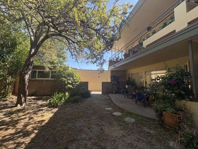 a view of a house with a yard and tree s