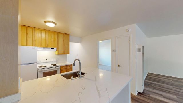 a kitchen with stainless steel appliances a stove a sink and a refrigerator