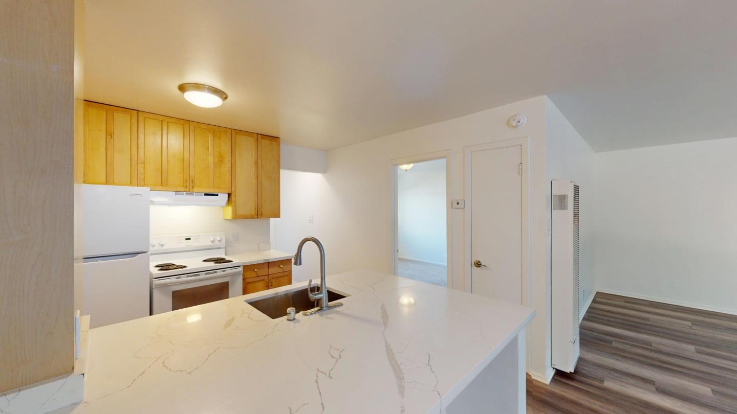 1222 Irwin Street San Rafael, CA 94901 - Photo 7 of 11 a kitchen with stainless steel appliances a stove a sink and a refrigerator