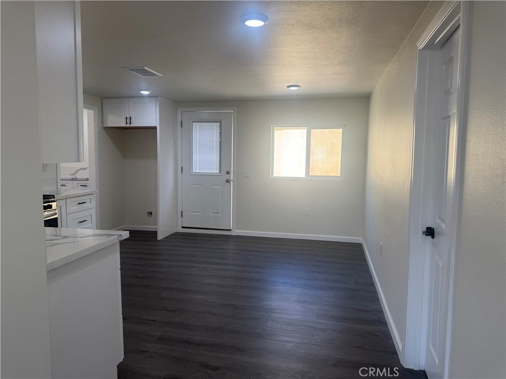 10337 Mull Avenue Riverside, CA 92505 - Photo 23 of 28 an empty room with wooden floor and a window