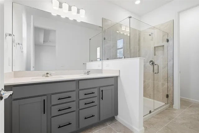 a bathroom with a shower and a sink