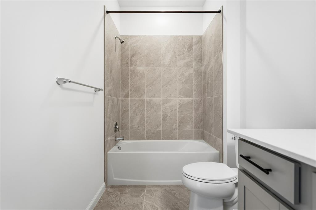 285 Southwest Sally Way Stuart, FL 34997 - Photo 19 of 48 a bathroom with a toilet and a bathtub