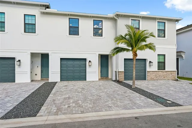 a house that has a palm tree in front of it