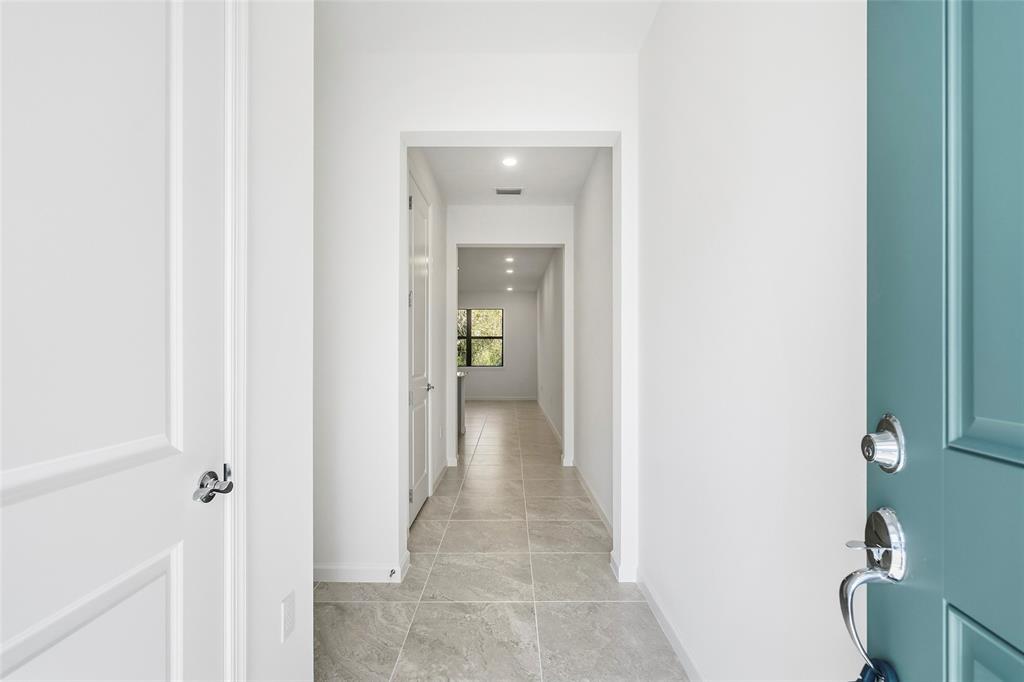 285 Southwest Sally Way Stuart, FL 34997 - Photo 32 of 48 a view of a hallway with wooden floor