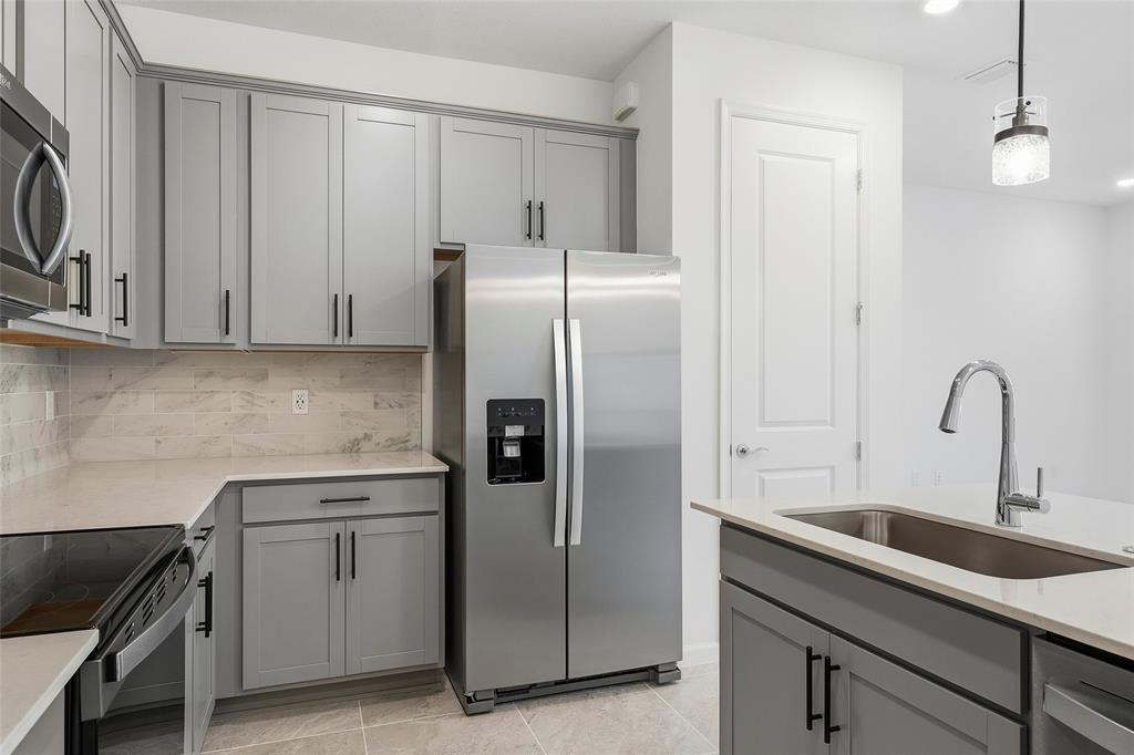 285 Southwest Sally Way Stuart, FL 34997 - Photo 4 of 48 a kitchen with a sink and cabinets