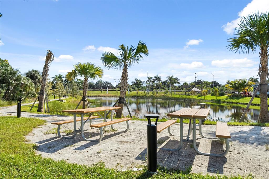 285 Southwest Sally Way Stuart, FL 34997 - Photo 43 of 48 a view of a lake with a bench and lake view