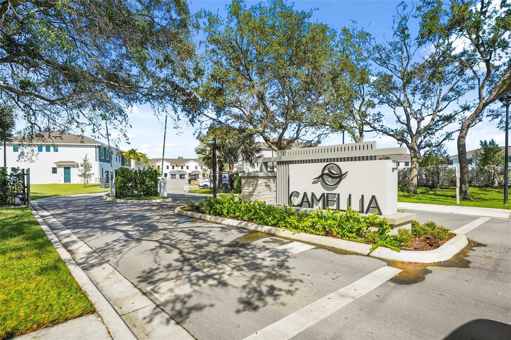 285 Southwest Sally Way Stuart, FL 34997 - Photo 47 of 48 a view of a white house next to a yard with big trees