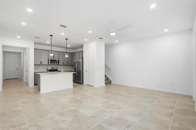 an empty room with windows and closet