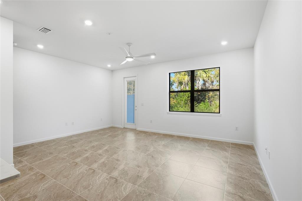 285 Southwest Sally Way Stuart, FL 34997 - Photo 10 of 48 wooden floor in an empty room with a window