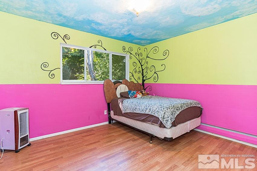 1595 Belford Road Reno, NV 89509 - Photo 11 of 21 a bedroom with a bed and wooden floor