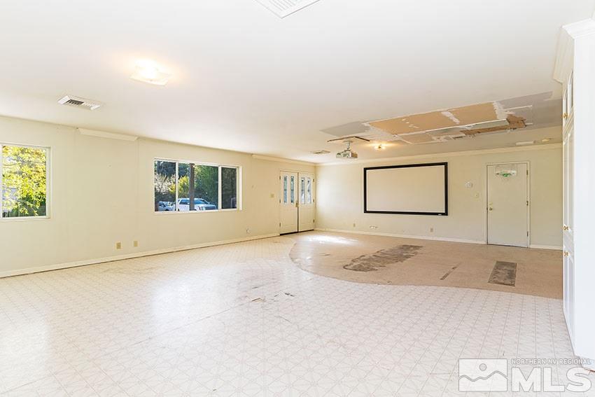 1595 Belford Road Reno, NV 89509 - Photo 3 of 21 a view of a livingroom with wooden floor and a ceiling fan