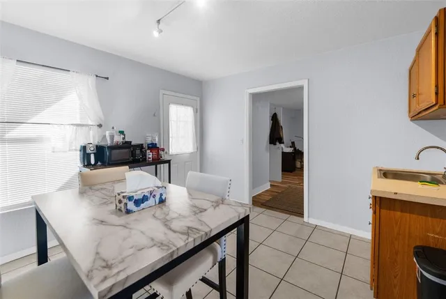 a view of a kitchen area with furniture and wooden floor
