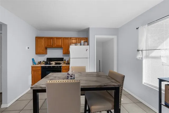 a kitchen with stainless steel appliances cabinets a table and chairs