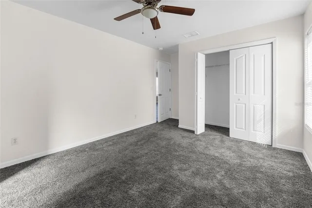 a bathroom with a granite countertop sink a toilet and a mirror