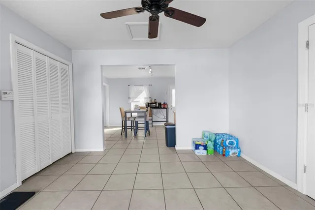 a room with furniture and view of kitchen