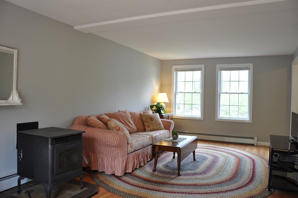 69 Haggerty Road Charlton, MA 01507 - Photo 15 of 30 a living room with furniture and a potted plant