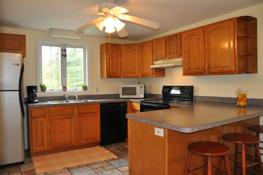 69 Haggerty Road Charlton, MA 01507 - Photo 2 of 30 a kitchen with stainless steel appliances granite countertop a sink stove and refrigerator