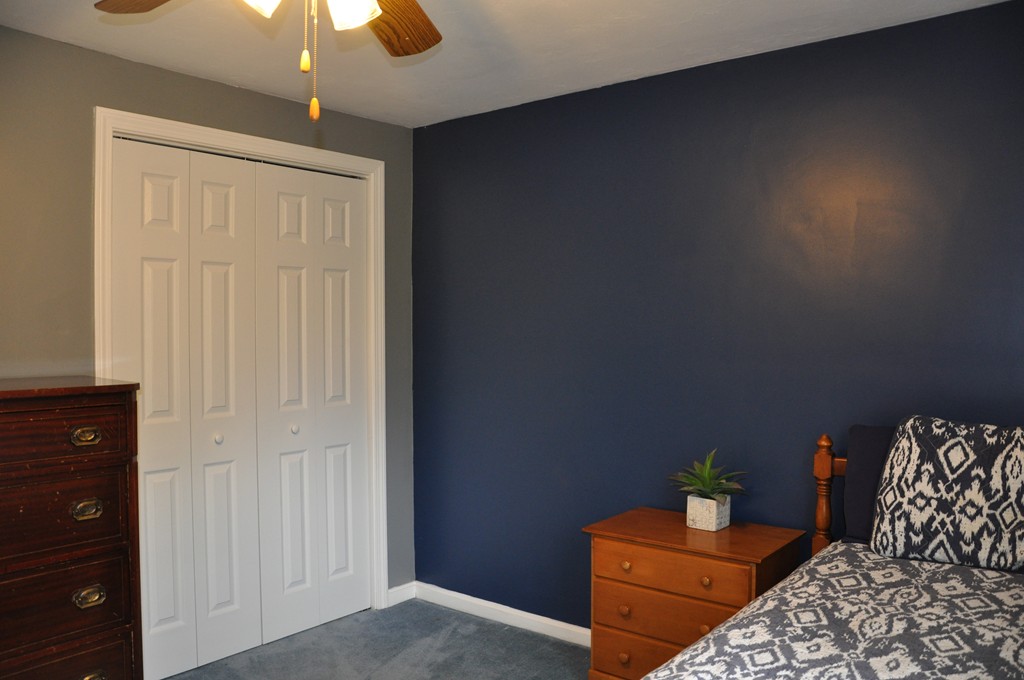 69 Haggerty Road Charlton, MA 01507 - Photo 22 of 30 a bedroom with furniture and a potted plant