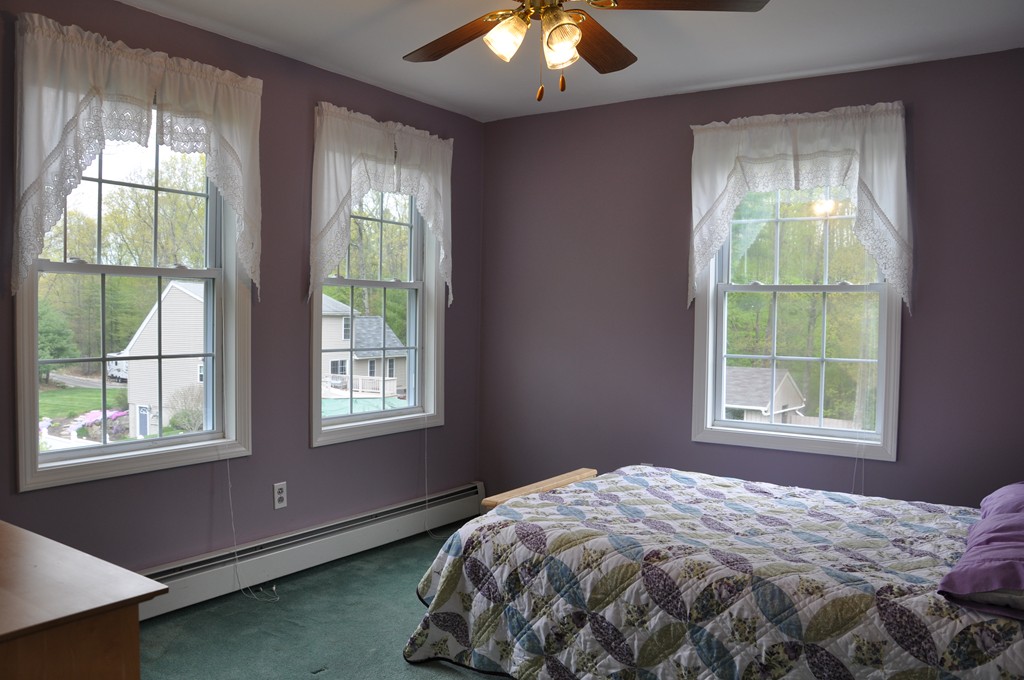 69 Haggerty Road Charlton, MA 01507 - Photo 24 of 30 a bed sitting in a bedroom next to a window