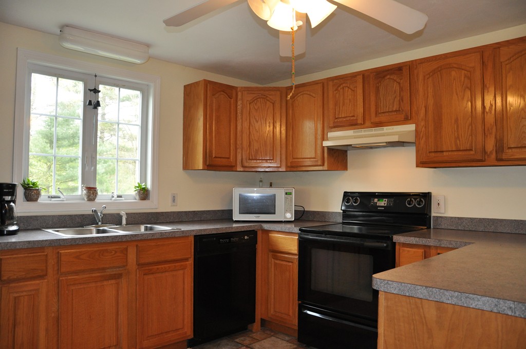 69 Haggerty Road Charlton, MA 01507 - Photo 4 of 30 a kitchen with stainless steel appliances granite countertop a sink stove and cabinets