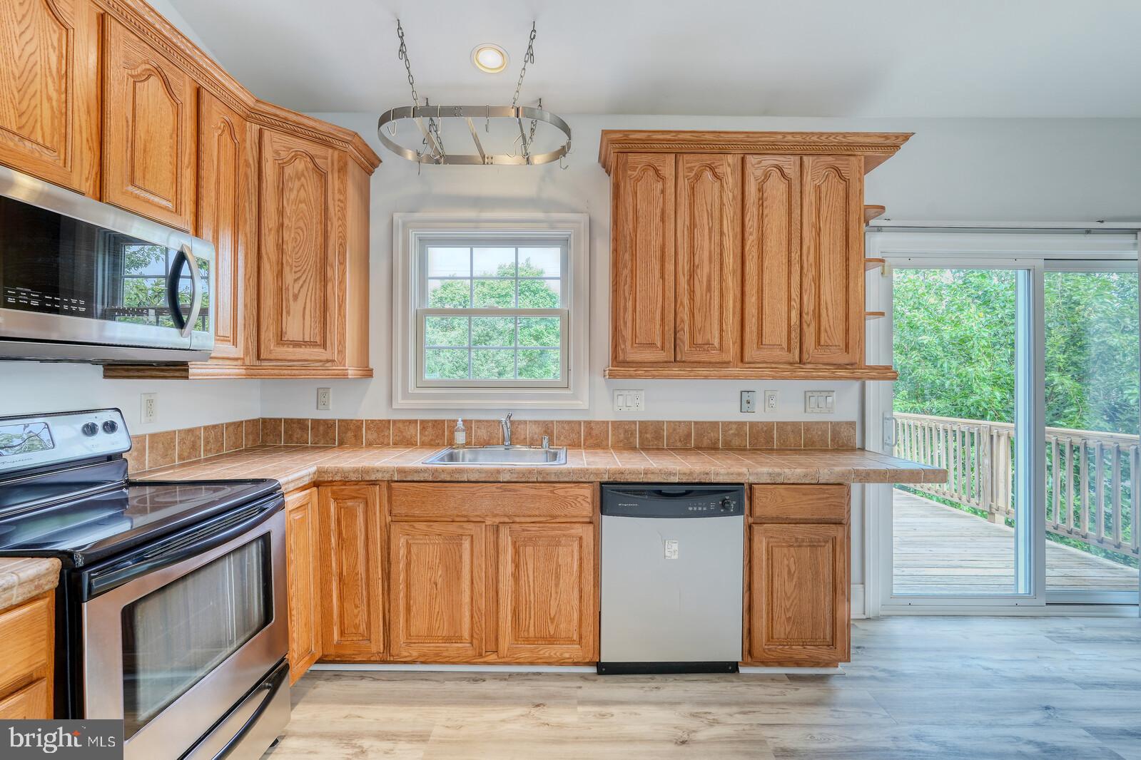 304 South Camp Meade Road Linthicum Heights, MD 21090 - Photo 13 of 43 a kitchen with stainless steel appliances granite countertop a sink stove and microwave
