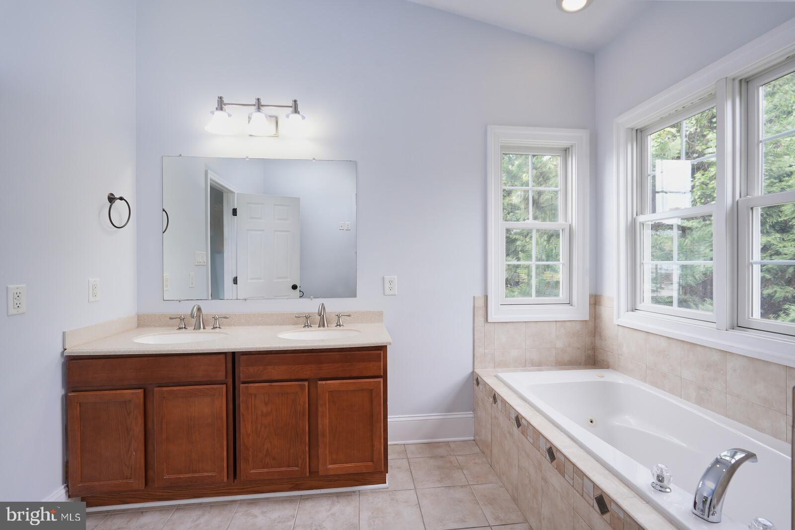 304 South Camp Meade Road Linthicum Heights, MD 21090 - Photo 18 of 43 a bathroom with a tub sink and mirror