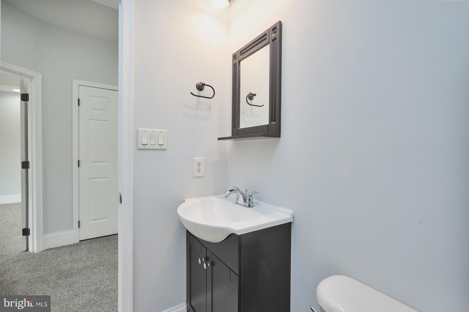 304 South Camp Meade Road Linthicum Heights, MD 21090 - Photo 25 of 43 a bathroom with a toilet sink and mirror