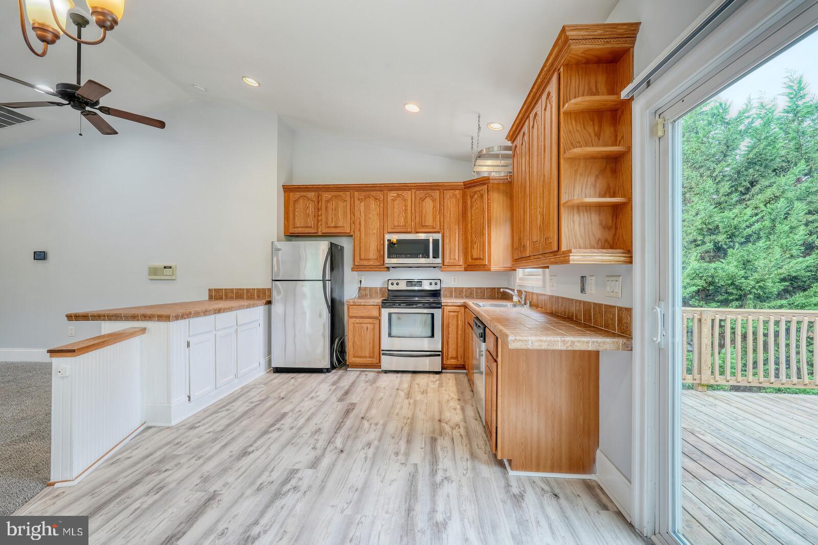 304 South Camp Meade Road Linthicum Heights, MD 21090 - Photo 10 of 43 a kitchen with stainless steel appliances granite countertop a stove a sink and a refrigerator