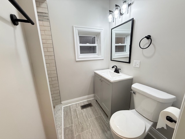 7045 South Prairie Avenue Chicago, IL 60637 - Photo 9 of 11 a white toilet sitting next to a bathroom sink