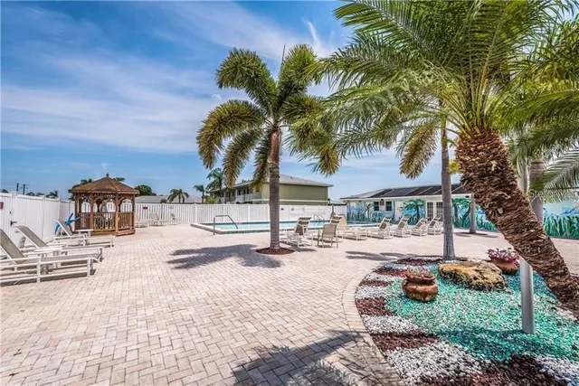 a view of swimming pool with outdoor seating and plants
