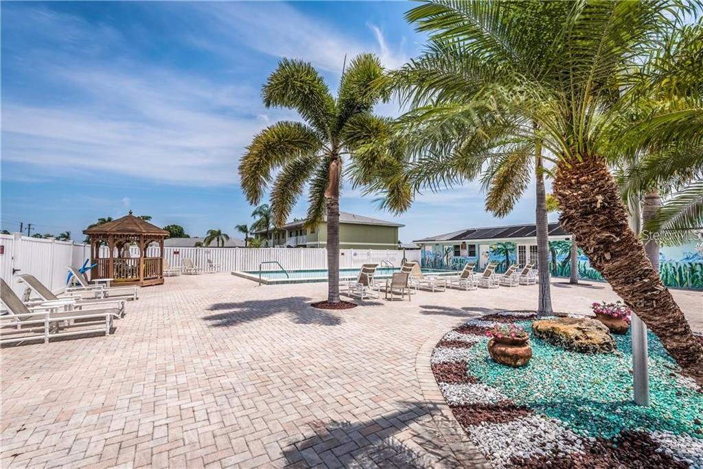 25225 Rampart Boulevard, Unit 1301 Punta Gorda, FL 33983 - Photo 17 of 19 a view of a swimming pool with a patio