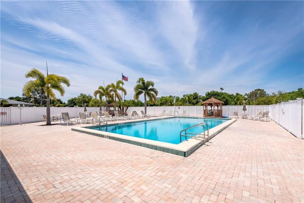 25225 Rampart Boulevard, Unit 1301 Punta Gorda, FL 33983 - Photo 19 of 19 a view of swimming pool with outdoor seating and plants