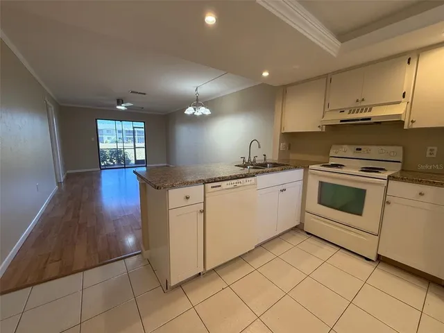a kitchen with cabinets and white appliances