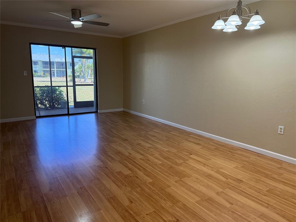 25225 Rampart Boulevard, Unit 1301 Punta Gorda, FL 33983 - Photo 5 of 19 a view of an empty room with wooden floor and a window
