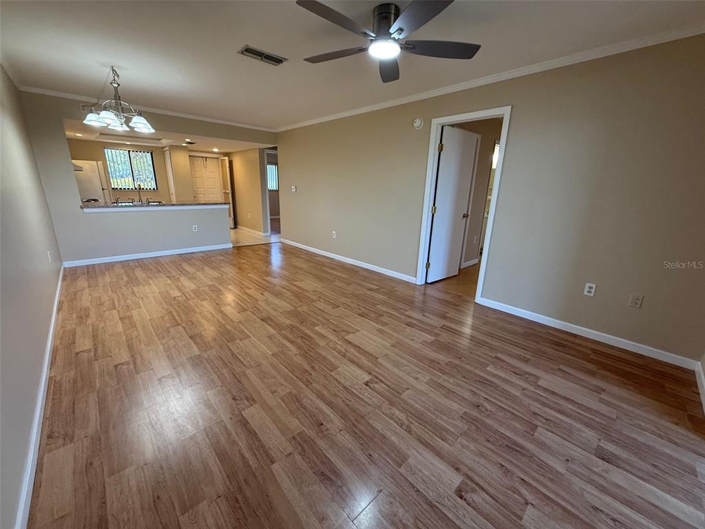 25225 Rampart Boulevard, Unit 1301 Punta Gorda, FL 33983 - Photo 7 of 19 a view of livingroom with hardwood floor and ceiling fan