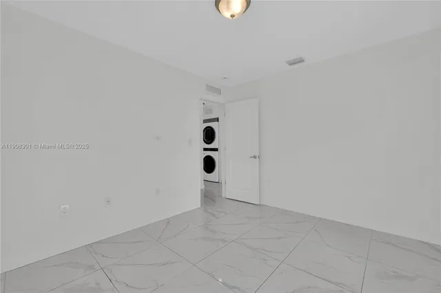 a view of a hallway with washer and dryer